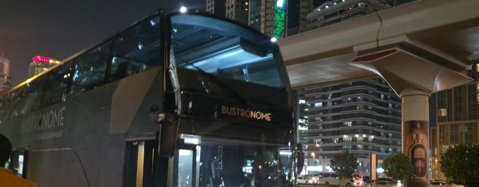 Restaurant bus roaming the Dubai skyline at night