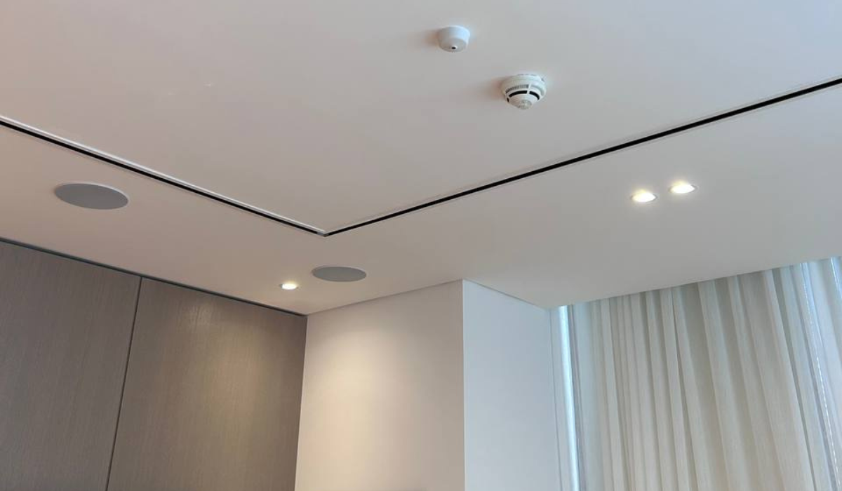 In-ceiling Artsound speakers installed flush into a villa corridor ceiling